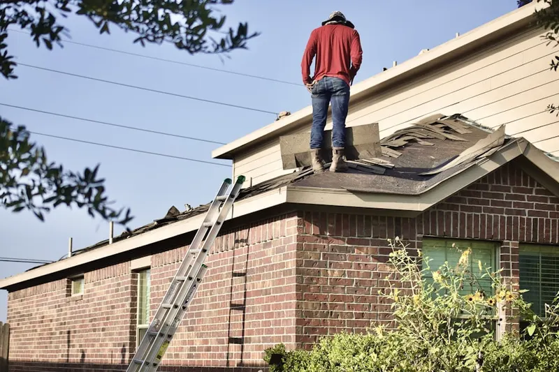 Professional roofer working on a residential roof in Lakes of the Four Seasons